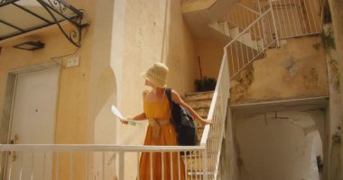 Amalfi kıyısında Atrani şehrinin dar sokaklarında gezen sırt çantalı bir kadın gezgin..