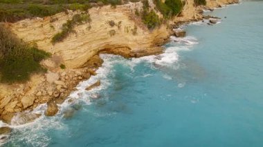 Yazın dalgalı mavi denizi olan Kefalonia kıyıları boyunca kayalıklar ve kayalıklar.