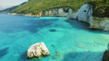 Kefalonya 'nın ormanlık kıyısı yakınlarında turkuaz ve derin mavi suları olan uçurum körfezi Yunanistan.