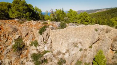 Kadın yazın Kefalonya 'da deniz ve çam ağaçlarıyla dağlarda yürür..