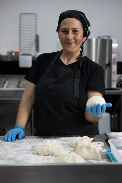 woman chef cooking meat for bakery