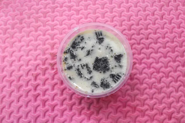 stock image vanilla and strawberry pudding with biscuit crumbs in mini cup isolated on pink background