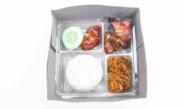 stock image Indonesian boxed rice with grilled chicken, fried noodles, sambal isolated on white background. Boxed rice for celebration or catering packaging as lunch box