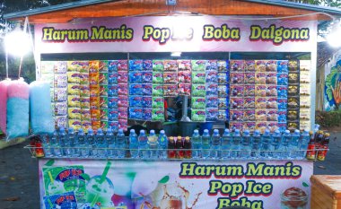 Indonesia - July 7, 2024: Sachet powder drink pop ice brand with various flavors at a street food drink seller clipart