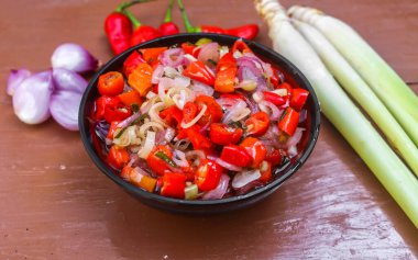 Endonezya Balili sambal matah 'ı mutfak baharatlarıyla süslenmiş bir kasede servis edildi. Acı biber, limon otu, soğan, limon yaprağı gibi ham baharatlardan yapılan bir çeşit kırmızı biber sosu..