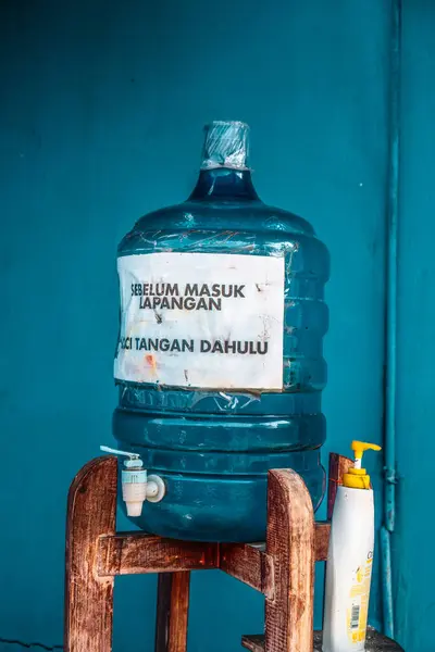 a simple hand washing place for the covid pandemic in front of the badminton court