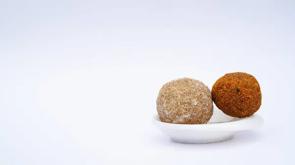 Gond & methi ke laddoo. Sweet Dink laddu also known as Dinkache ladu in Marathi. Recipe ingedients such as fry fruits, Fenugreek seeds, Khaskhas, Edible gum, Garden Cress Seeds, sugar. copy space.