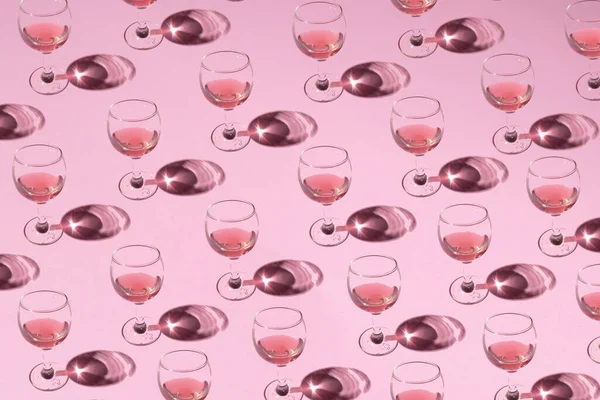 stock image Champagne glass with drink on the pink background. Christmas and New year celebration idea. Creative pattern.