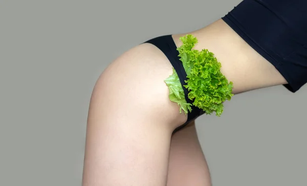 slim woman eating salad leaf lettuce sexy belly postpartum after childbirth.woman thumbs up for fit abdomen and down for fat.girl in underwear