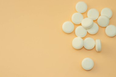 pills isolated medicine medical concept.white round red heart shaped pills chaotic or in row on green blue black orange paper from bottle disease treatment.arrow from tablets money coin plastic blister