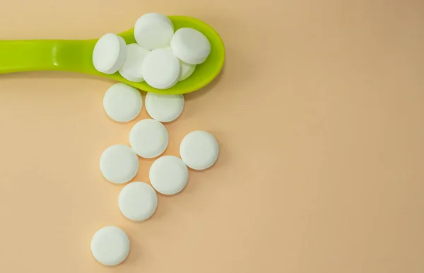pills isolated medicine medical concept.white round red heart shaped pills chaotic or in row on green blue black orange paper from bottle disease treatment.arrow from tablets money coin plastic blister