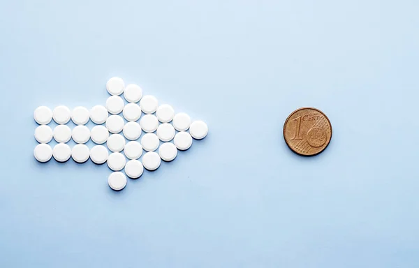 pills isolated medicine medical concept.white round red heart shaped pills chaotic or in row on green blue black orange paper from bottle disease treatment.arrow from tablets money coin plastic blister