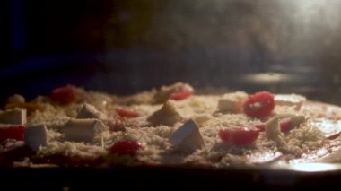 step by step homemade pizza from kneading the dough to ready in electric owen.woman hand make dough pizza crust pouring tomato pasta salami slices cheese other ingredients.glass with champagne 