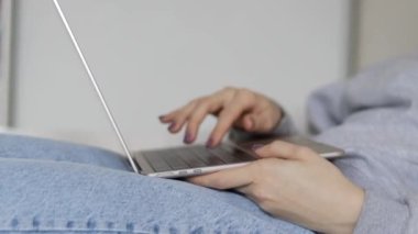 work from home remote job woman using laptop for business communication meeting fun.female girl maternity leaves on baby bed or minimalist small table hands gestures.red paper heart wooden rabbit toy 