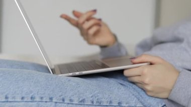 work from home remote job woman using laptop for business communication meeting fun.female girl maternity leaves on baby bed or minimalist small table hands gestures.red paper heart wooden rabbit toy 