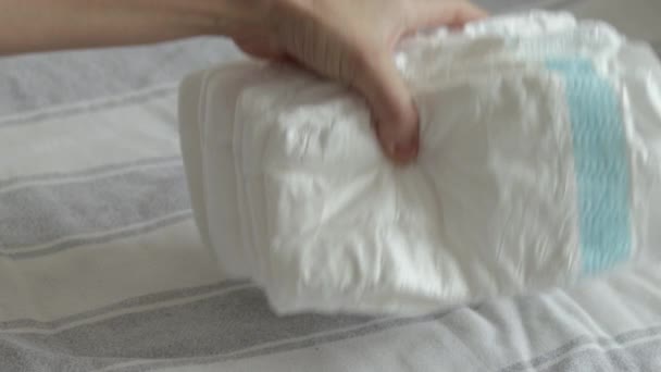 Baby Diapers Pack Woman Mother Hand Bed Finger Counting Throwing — Stockvideo