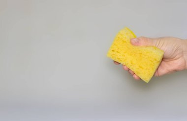 two sponges for cleaning. yellow, blue colors. space for text. Kitchen cleaning set sponge background. sponge in womans hand. space for text. 