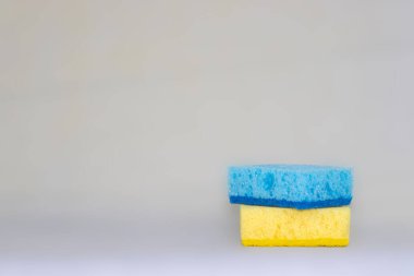 two sponges for cleaning. yellow, blue colors. space for text. Kitchen cleaning set sponge background. sponge in womans hand. space for text. 