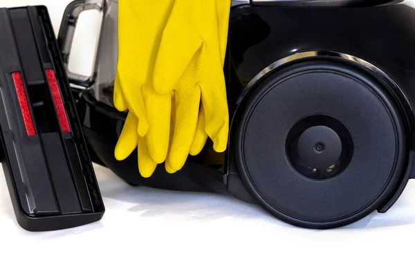 woman holding vacuum cleaner handle carpet floor brush isolated housekeeping cleaning concept.girl wear latex gloves yellow.beige background free space for text mockup advertising banner for agencies