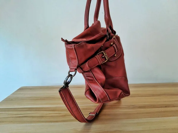 A women brown leather bag capture hanging from side