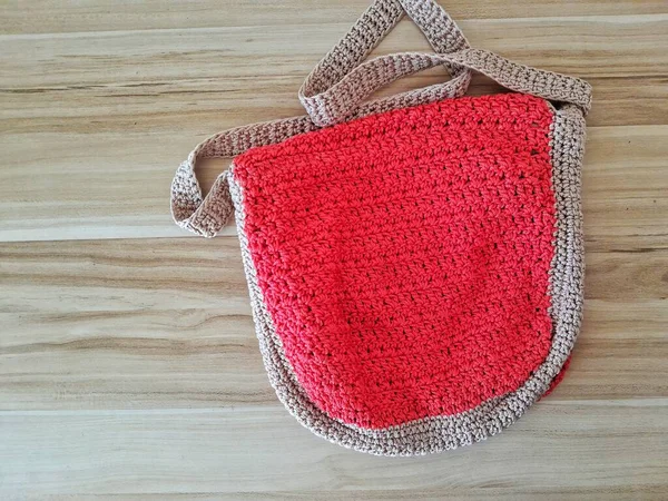 The Red Knitting women bag on wooden table