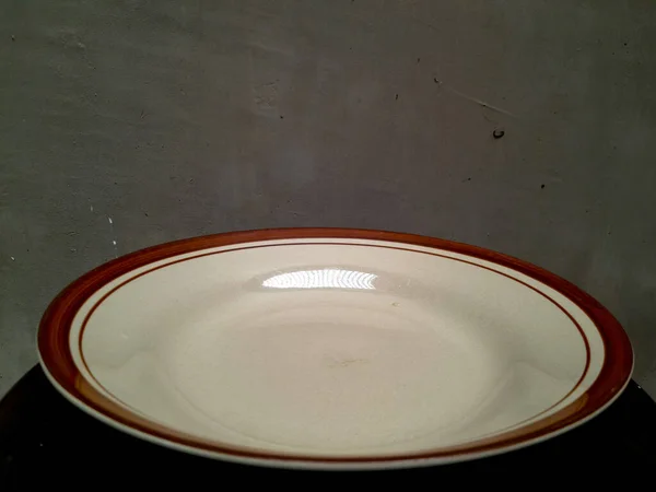 brown round ceramic plate with stripes on the sides