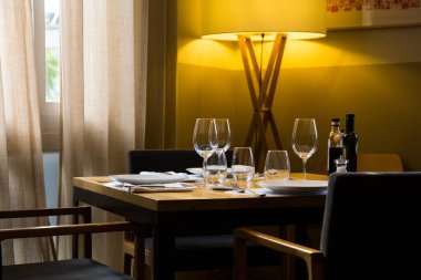 Elegant restaurant table with cutlery, crockery and glasses.
