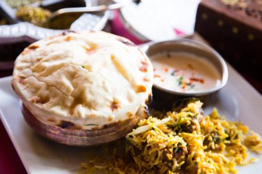 Naan is a flat bread, made from wheat flour and usually leavened. It is commonly consumed in several regions of Central Asia and South Asia: Afghanistan, Iran, Uzbekistan, Burma, Pakistan, and northwest