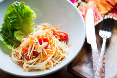 Green papaya salad is a spicy salad made from grated green papaya.