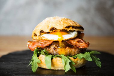 Authentic top quality American Burger with bacon, egg and salad.