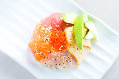 Salmon sashimi. Sashimi is a Japanese dish that consists mainly of raw seafood or fish, finely sliced, although not as finely as a carpaccio.