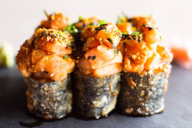 Salmon hot roll. Sushi roll stuffed with salmon and fried whole with breadcrumbs.