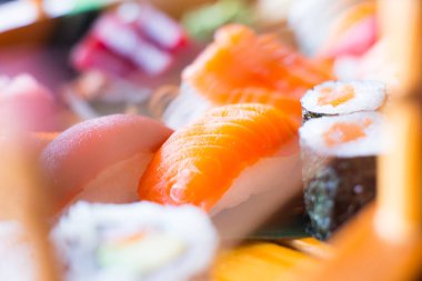 Set of sushi with variety of makis, nigiris and sashimi with fine fish like salmon and tuna.