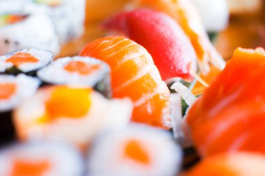 Set of sushi with variety of makis, nigiris and sashimi with fine fish like salmon and tuna.