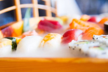 Set of sushi with variety of makis, nigiris and sashimi with fine fish like salmon and tuna.