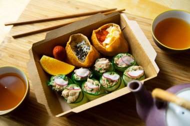 Sushi box with nigiris and tofu bags 