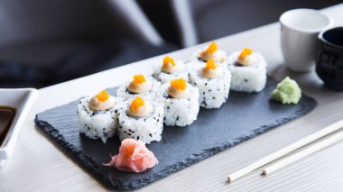 Uramaki sushi with rice and seaweed stuffed with vegetables and vegetarian ingredients.