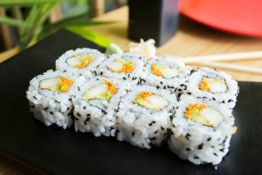 Uramaki sushi with rice and seaweed stuffed with vegetables and vegetarian ingredients.