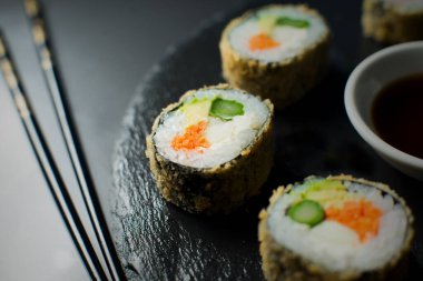 Fried vegan sushi roll with breadcrumbs. Rice roll stuffed with vegetables.