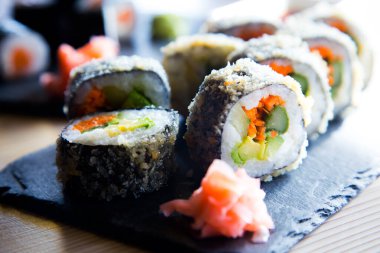 Fried vegan sushi roll with breadcrumbs. Rice roll stuffed with vegetables.
