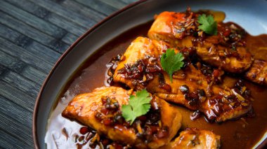 Salmon cooked with teriyaki sauce. Traditional Japanese recipe.