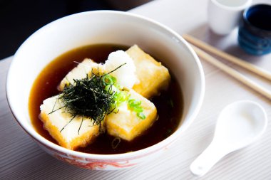 Miso soup is a Japanese soup made from a dashi broth and miso paste, which gives it its name. It can be served with tofu or noodles.