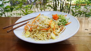 Rice noodles with vegetables and meat in a Japanese restaurant.  