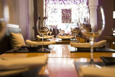 Elegant restaurant table with cutlery, crockery and glasses.