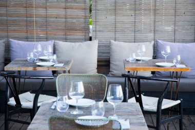 Elegant restaurant table with cutlery, crockery and glasses.
