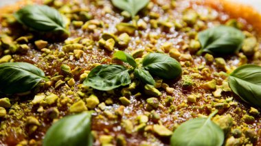 Cheesecake with quince and pistachio topping.