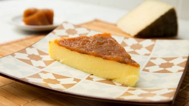 Cheesecake with quince and pistachio topping.