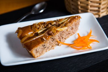 Slice of walnut cake with caramel.