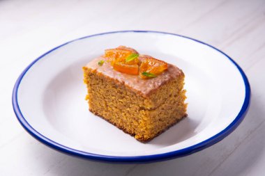 Orange sponge cake with nuts and candied fruit.