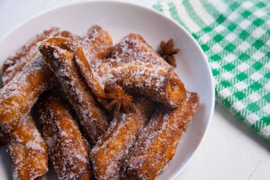 Canutillo de ans,  is a type of pan fruit that is usually served as a Christmas or Easter sweet, typical of Andalusia and other areas of Spain, made with flour dough, fried in olive oil and soaked in honey.